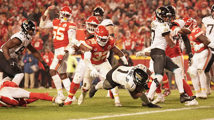 Jan 21, 2023; Kansas City, Missouri, USA; Jacksonville Jaguars running back Travis Etienne Jr. (1) scores a touchdown against the Kansas City Chiefs during the second half in the AFC divisional round game at GEHA Field at Arrowhead Stadium. Mandatory Credit: Denny Medley-Imagn Images