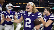 Dec 26, 2024; Phoenix, AZ, USA; Kansas State Wildcats quarterback Avery Johnson (2) celebrates after defeating the Rutgers Scarlet Knights during the Rate Bowl at Chase Field. Mandatory Credit: Mark J. Rebilas-Imagn Images