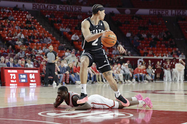 Mississippi State guard Riley Kugel (2) grabs a loose ball after Oklahoma Sooners guard Duke Miles (15) falls to the ground.