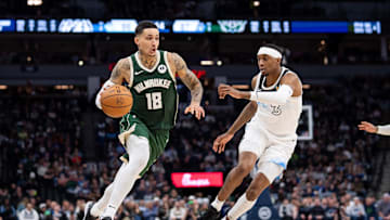 Feb 12, 2025; Minneapolis, Minnesota, USA; Milwaukee Bucks forward Kyle Kuzma (18) dribbles against Minnesota Timberwolves forward Jaden McDaniels (3) in the fourth quarter at Target Center. Mandatory Credit: Brad Rempel-Imagn Images