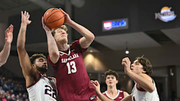 Feb 24, 2024; Spokane, Washington, USA; Santa Clara Broncos center Christoph Tilly (13) shoots the ball against Gonzaga Bulldogs forward Anton Watson (22) in the first half at McCarthey Athletic Center. Mandatory Credit: James Snook-Imagn Images
