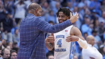 Mar 5, 2024; Chapel Hill, North Carolina, USA; North Carolina Tar Heels head coach Hubert Davis hugs guard RJ Davis (4) on senior night during the second half against the Notre Dame Fighting Irish at Dean E. Smith Center. Mandatory Credit: Jim Dedmon-USA TODAY Sports