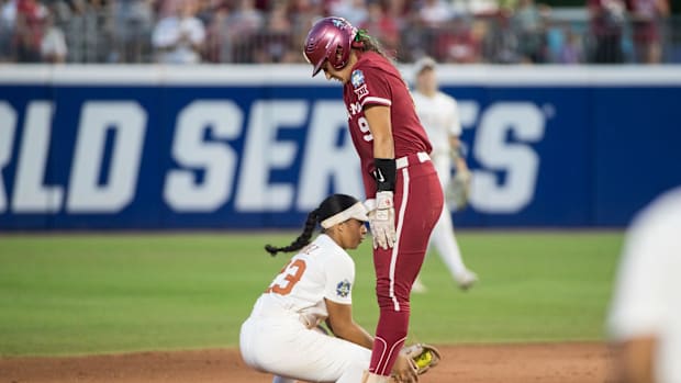 Jun 6, 2024; Oklahoma City, OK, USA;  Oklahoma Sooners catcher Kinzie Hansen (9) is safe at second as the tag by Texas Longho