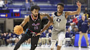 Jan 24, 2024; Houston, Texas, USA; Rice Owls guard Noah Shelby (1) defends against Florida Atlantic Owls guard Jalen Gaffney (12) during the second half at Tudor Fieldhouse. Mandatory Credit: Troy Taormina-Imagn Images