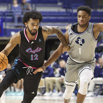 Jan 24, 2024; Houston, Texas, USA; Rice Owls guard Noah Shelby (1) defends against Florida Atlantic Owls guard Jalen Gaffney (12) during the second half at Tudor Fieldhouse. Mandatory Credit: Troy Taormina-Imagn Images