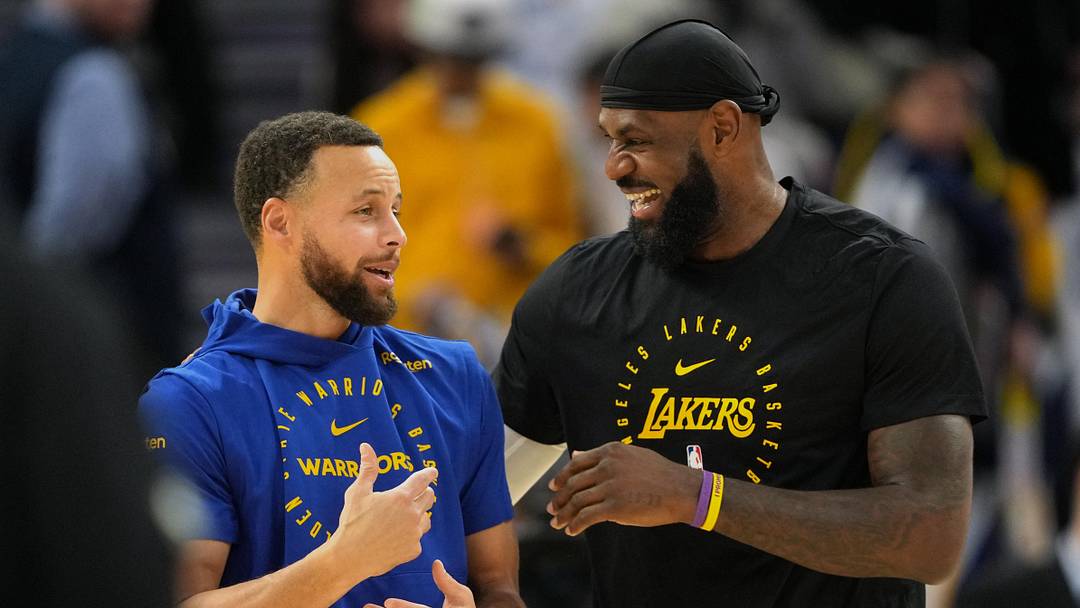 Dec 25, 2024; San Francisco, California, USA; Golden State Warriors guard Stephen Curry (left) and Los Angeles Lakers forward LeBron James (right) talk before the game at Chase Center. Mandatory Credit: Darren Yamashita-Imagn Images