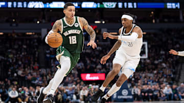 Feb 12, 2025; Minneapolis, Minnesota, USA; Milwaukee Bucks forward Kyle Kuzma (18) dribbles against Minnesota Timberwolves forward Jaden McDaniels (3) in the fourth quarter at Target Center. Mandatory Credit: Brad Rempel-Imagn Images