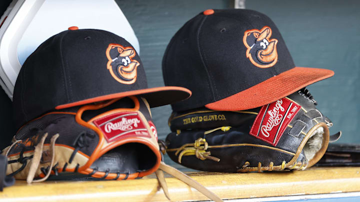 Baltimore Orioles hats and glove sits in dugout