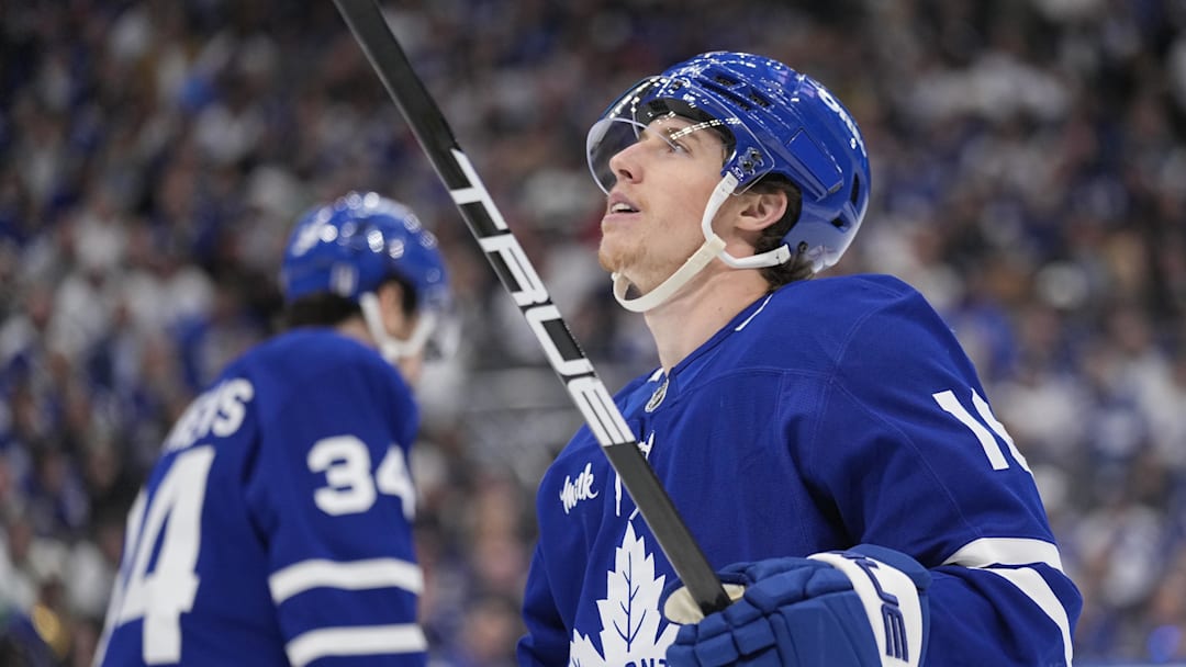 May 18, 2025; Toronto, Ontario, CAN; Toronto Maple Leafs forward Mitch Marner (16) looks up at the scoreboard as Toronto Maple Leafs forward Auston Matthews (34) skates to the bench during the third period of game seven of the second round of the 2025 Stanley Cup Playoffs against the Florida Panthers at Scotiabank Arena. Mandatory Credit: John E. Sokolowski-Imagn Images