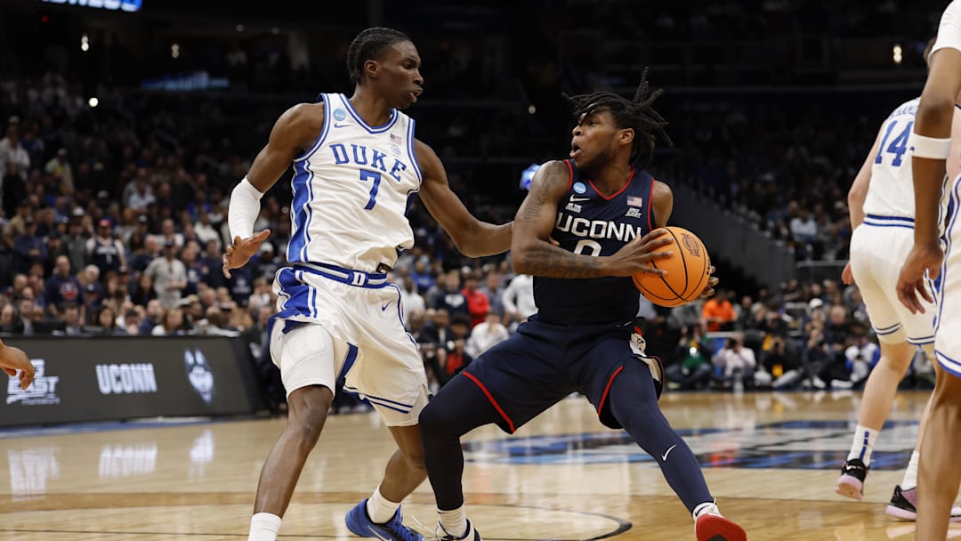 Mar 29, 2026; Washington, DC, USA; UConn Huskies guard Malachi Smith (0) drives to the basket as Duke Blue Devils guard Dame Sarr (7) defends during an Elite Eight game of the East Regional of the men's 2026 NCAA Tournament at Capital One Arena. Mandatory Credit: Geoff Burke-Imagn Images