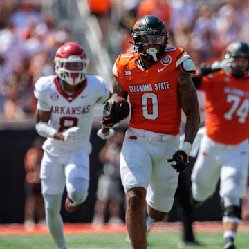 Sep 7, 2024; Stillwater, Oklahoma, USA; Oklahoma State Cowboys running back Ollie Gordon II (0) runs the ball during the fourth quarter against the Arkansas Razorbacks at Boone Pickens Stadium. Mandatory Credit: William Purnell-Imagn Images