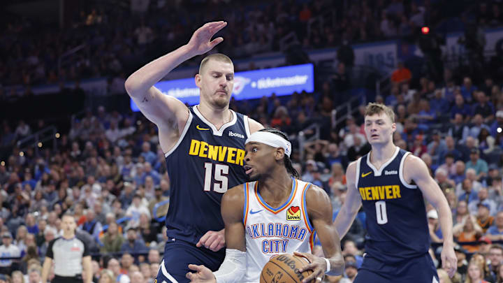 Mar 10, 2025; Oklahoma City, Oklahoma, USA; Denver Nuggets center Nikola Jokic (15) defends a drive by Oklahoma City Thunder guard Shai Gilgeous-Alexander (2) during the second half at Paycom Center. Mandatory Credit: Alonzo Adams-Imagn Images Mar 10, 2025; Oklahoma City, Oklahoma, USA; Denver Nuggets center Nikola Jokic (15) defends a drive by Oklahoma City Thunder guard Shai Gilgeous-Alexander (2) during the second half at Paycom Center. Mandatory Credit: Alonzo Adams-Imagn Images