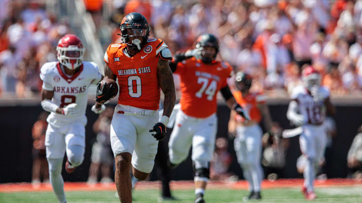 Sep 7, 2024; Stillwater, Oklahoma, USA; Oklahoma State Cowboys running back Ollie Gordon II (0) runs the ball during the fourth quarter against the Arkansas Razorbacks at Boone Pickens Stadium. Mandatory Credit: William Purnell-Imagn Images