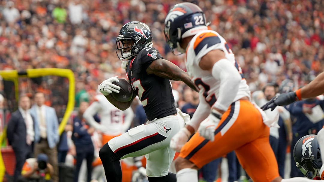 Nov 2, 2025; Houston, Texas, USA; Houston Texans wide receiver Nico Collins (12) runs against Denver Broncos safety Brandon Jones (22) during the first half at NRG Stadium. Mandatory Credit: Sean Thomas-Imagn Images