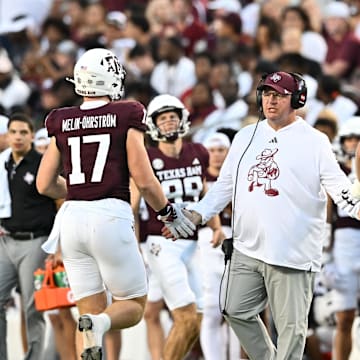 Aug 31, 2024; College Station, Texas, USA; Texas A&M Aggies head coach Mike Elko high fives players as they exit the field during the second quarter against the Notre Dame Fighting Irish at Kyle Field. Mandatory Credit: Maria Lysaker-Imagn Images