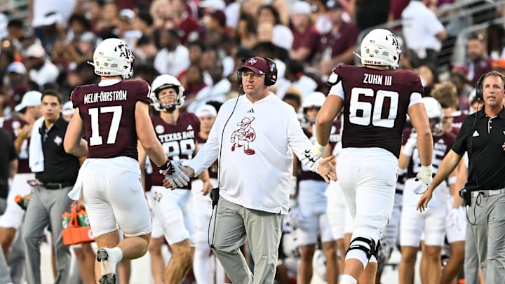 Aug 31, 2024; College Station, Texas, USA; Texas A&M Aggies head coach Mike Elko high fives players as they exit the field during the second quarter against the Notre Dame Fighting Irish at Kyle Field. Mandatory Credit: Maria Lysaker-Imagn Images