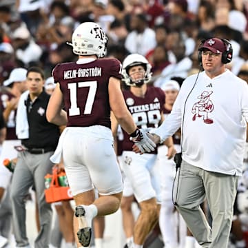 Aug 31, 2024; College Station, Texas, USA; Texas A&M Aggies head coach Mike Elko high fives players as they exit the field during the second quarter against the Notre Dame Fighting Irish at Kyle Field. Mandatory Credit: Maria Lysaker-Imagn Images