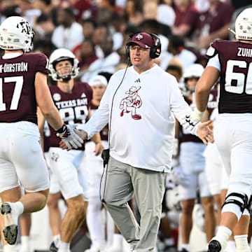 Aug 31, 2024; College Station, Texas, USA; Texas A&M Aggies coach Mike Elko high fives players as they exit the field during the second quarter against the Notre Dame Fighting Irish at Kyle Field.