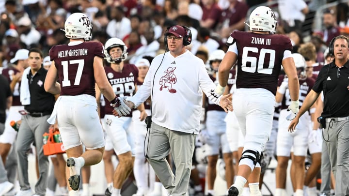 Aug 31, 2024; College Station, Texas, USA; Texas A&M Aggies coach Mike Elko high fives players as they exit the field during the second quarter against the Notre Dame Fighting Irish at Kyle Field.