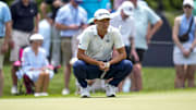 Collin Morikawa looks over the green at the fifth hole