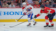 Dec 28, 2024; Sunrise, Florida, USA; Montreal Canadiens right wing Cole Caufield (13) shoots the puck past Florida Panthers defenseman Dmitry Kulikov (7) during the second period at Amerant Bank Arena. Mandatory Credit: Sam Navarro-Imagn Images