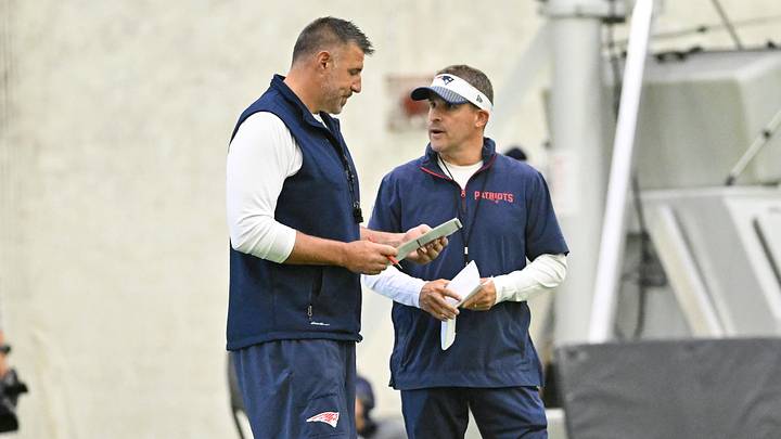 Jun 10, 2025; Foxborough, MA, USA; New England Patriots head coach Mike Vrabel (l) and offensive coordinator Josh McDaniels (r) speak to each other during minicamp held in the WIN Field House at Gillette Stadium. Mandatory Credit: Eric Canha-Imagn Images