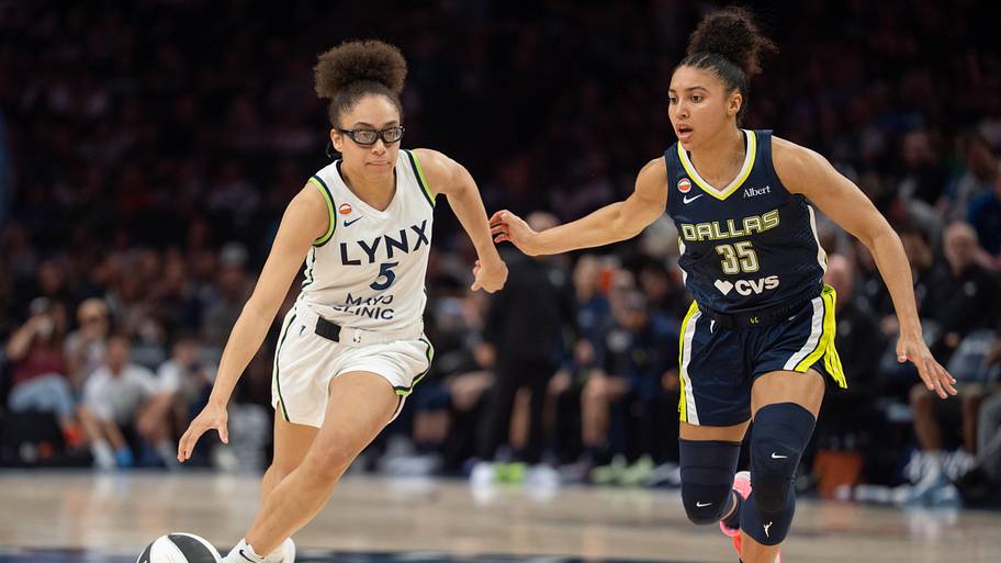 Lynx guard Olivia Miles (5) drives by the defense of Dallas Wings guard Azzi Fudd 