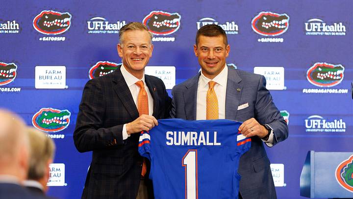 Dec 1, 2025; Gainesville, FL, USA; Florida Gators athletic director Scott Stricklin and Florida Gators head coach Jon Sumrall poses with a Florida Gators jersey during the press conference at the Heavener Football Training Center at the University of Florida. Mandatory Credit: Matt Pendleton-Imagn Images