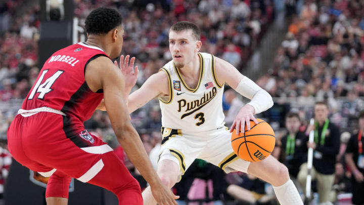 North Carolina State Wolfpack guard Casey Morsell (14) defends Purdue Boilermakers guard Braden Smith (3) 