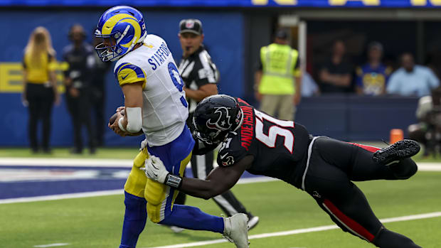 Sep 7, 2025; Inglewood, California, USA; Los Angeles Rams quarterback Matthew Stafford (9) is sacked by Houston Texans defens