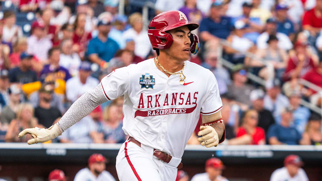 Jun 14, 2025; Omaha, Neb, USA; Arkansas Razorbacks shortstop Wehiwa Aloy (9) runs after hitting a single against the LSU Tigers during the fourth inning at Charles Schwab Field.