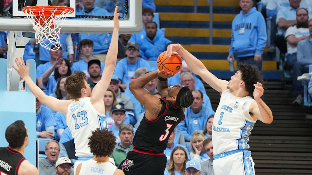 Feb 23, 2026; Chapel Hill, North Carolina, USA; Louisville Cardinals guard Ryan Conwell (3) shoots as North Carolina Tar Heels center Henri Veesaar (13) and forward Zayden High (1) defend in the second half at Dean E. Smith Center. Mandatory Credit: Bob Donnan-Imagn Images