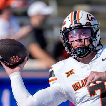 Oklahoma State quarterback Alan Bowman (7) warms up before an NCAA football game between Oklahoma State and Tulsa in Tulsa, Okla., on Saturday, Sept. 14, 2024.