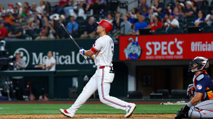 Aug 6, 2024; Arlington, Texas, USA; Texas Rangers shortstop Corey Seager (5) hits a two-run home run during the ninth inning against the Houston Astros at Globe Life Field. Mandatory Credit: Kevin Jairaj-USA TODAY Sports