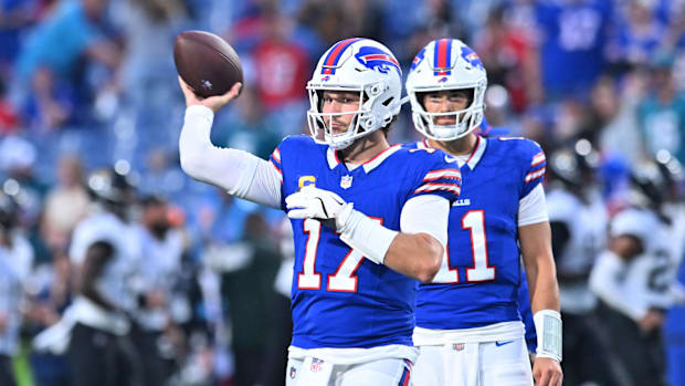 Buffalo Bills quarterback Josh Allen (17) warms up as quarterback Mitchell Trubisky (11) looks on before a game against the J