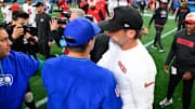 Oct 10, 2024; Seattle, Washington, USA; Seattle Seahawks Mike McDonald and San Francisco 49ers head coach Kyle Shanahan greet after the game at Lumen Field. Mandatory Credit: Steven Bisig-Imagn Images