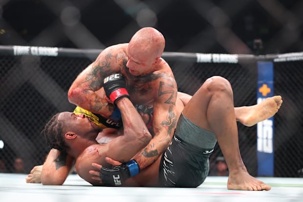 Khaos Williams (red gloves) fights Andreas Gustafsson (blue gloves) during UFC 316 at Prudential Center.