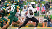 Nov 1, 2025; Waco, Texas, USA; UCF Knights running back Myles Montgomery (22) carries the ball as Baylor Bears safety Jacob Redding (38) defends during the first half at McLane Stadium. Mandatory Credit: Raymond Carlin III-Imagn Images
