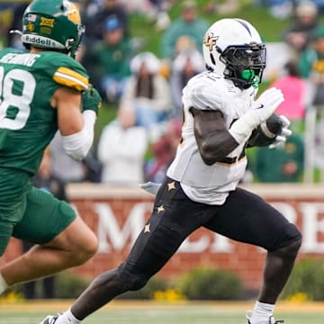 Nov 1, 2025; Waco, Texas, USA; UCF Knights running back Myles Montgomery (22) carries the ball as Baylor Bears safety Jacob Redding (38) defends during the first half at McLane Stadium. Mandatory Credit: Raymond Carlin III-Imagn Images
