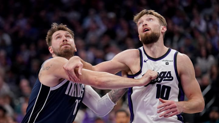 Mar 29, 2024; Sacramento, California, USA; Dallas Mavericks guard Luka Doncic (77) and Sacramento Kings forward Domantas Sabonis (10) battle for position in the third quarter at the Golden 1 Center. Mandatory Credit: Cary Edmondson-Imagn Images