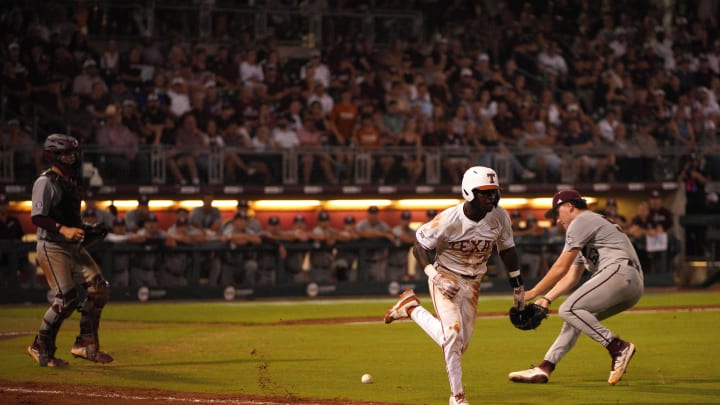 June 1, 2024; College Station, TX, USA; Texas Longhorns infielder Dee Kennedy (30) races to beat the throw by Texas A&M Aggies pitcher Evan Aschenbeck (53) during the second round in the NCAA baseball College Station Regional at Olsen Field College Station. Mandatory Credit: Dustin Safranek-USA TODAY Sports