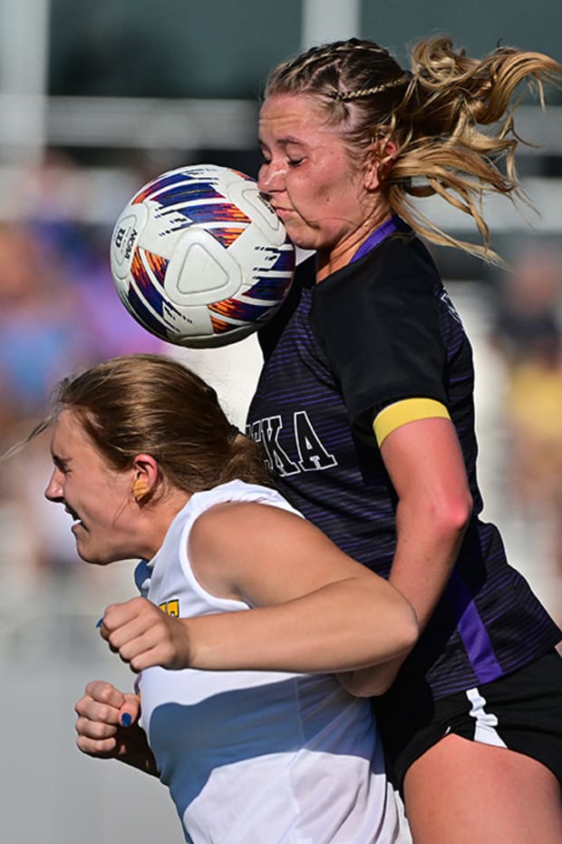 Eureka (Mo.) defender Callaway Combs (right) gets a faceful of the ball off a header by Lafayette forward Aubrey Sinn in the MSHSAA Class 4 District 4 girls soccer title game at Eureka High School.
