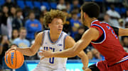 Nov 10, 2025; Los Angeles, California, USA;  UCLA Bruins guard Trent Perry (0) is defended by West Georgia Wolves guard Chas Lewless (2) during the second half at Pauley Pavilion presented by Wescom Financial. Mandatory Credit: Jayne Kamin-Oncea-Imagn Images