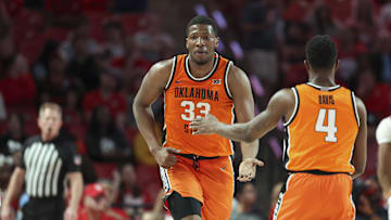 Feb 4, 2025; Houston, Texas, USA; Oklahoma State Cowboys forward Abou Ousmane (33) celebrates with guard Davonte Davis (4) after a play during the first half against the Houston Cougars at Fertitta Center. Mandatory Credit: Troy Taormina-Imagn Images