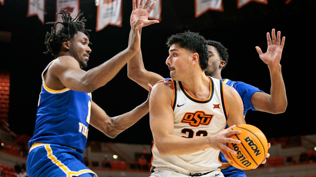 Feb 24, 2026; Stillwater, Oklahoma, USA; Oklahoma State Cowboys forward Parsa Fallah (22) protects the ball during the first half against the West Virginia Mountaineers at Gallagher-Iba Arena. Mandatory Credit: William Purnell-Imagn Images