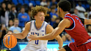 Nov 10, 2025; Los Angeles, California, USA;  UCLA Bruins guard Trent Perry (0) is defended by West Georgia Wolves guard Chas Lewless (2) during the second half at Pauley Pavilion presented by Wescom Financial. Mandatory Credit: Jayne Kamin-Oncea-Imagn Images