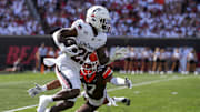 Sep 6, 2025; Cincinnati, Ohio, USA; Cincinnati Bearcats running back Manny Covey (29) carries the ball as he is tackled by Bowling Green Falcons wide receiver Trey Johnson (17) during a kick off in the first half at Nippert Stadium. Mandatory Credit: Aaron Doster-Imagn Images