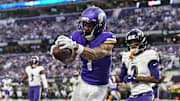 Nov 9, 2025; Minneapolis, Minnesota, USA; Minnesota Vikings wide receiver Jalen Nailor (1) scores on a touchdown pass as Baltimore Ravens cornerback Nate Wiggins (2) defends during the fourth quarter at U.S. Bank Stadium. Mandatory Credit: Jeffrey Becker-Imagn Images