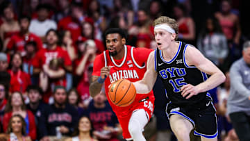 Feb 22, 2025; Tucson, Arizona, USA; BYU Cougars guard Richie Saunders (15) dribbles the ball while Arizona Wildcats guard KJ Lewis (5) follows him during the first half at McKale Center. Mandatory Credit: Aryanna Frank-Imagn Images