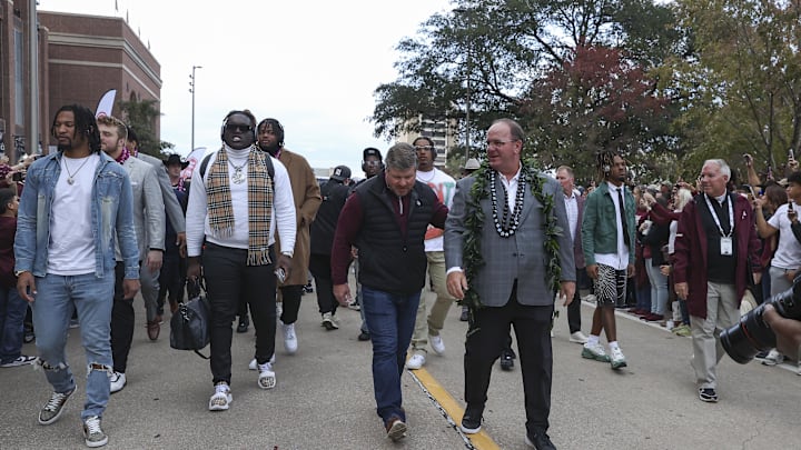Nov 30, 2024; College Station, Texas, USA; Texas A&M Aggies head coach Mike Elko walks in with players before the game against the Texas Longhorns at Kyle Field. Mandatory Credit: Troy Taormina-Imagn Images
